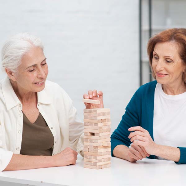 Two older women playing Jenga.